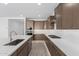 Modern kitchen with stainless steel appliances, white countertops, and wooden cabinets at 7342 W Hedge Hog Pl, Peoria, AZ 85383