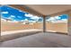 Covered patio offers an outdoor space for relaxation and features an empty backyard space with block fence at 7342 W Hedge Hog Pl, Peoria, AZ 85383