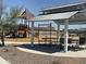 A playground with a swing set and slides surrounded by a picnic shelter at 7674 W Rowel Rd, Peoria, AZ 85383