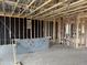 View inside the property shows black insulation, wood beams, and the initial stages of electrical work at 7674 W Rowel Rd, Peoria, AZ 85383