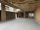 Spacious interior under construction features exposed wood framing, concrete floors, and ample natural light at 7674 W Rowel Rd, Peoria, AZ 85383