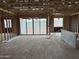 View of an open concept living room under construction, with large sliding glass doors leading to the backyard at 7674 W Rowel Rd, Peoria, AZ 85383