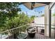 Cozy balcony featuring an outdoor seating area, views of trees, and a ceiling fan at 7740 E Heatherbrae Ave # 13, Scottsdale, AZ 85251
