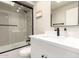 Bathroom with a glass enclosed shower, white vanity, matte black finishes, and modern accents at 7740 E Heatherbrae Ave # 13, Scottsdale, AZ 85251