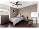 Cozy bedroom features a brick wall, ceiling fan, and a dark wood floor and desk at 7740 E Heatherbrae Ave # 13, Scottsdale, AZ 85251