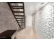 Modern hallway featuring a unique textured wall and an open staircase to the upper level at 7740 E Heatherbrae Ave # 13, Scottsdale, AZ 85251