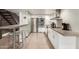 Sleek, modern kitchen featuring stainless steel appliances, a concrete countertop, and white cabinetry at 7740 E Heatherbrae Ave # 13, Scottsdale, AZ 85251