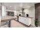Modern kitchen with stainless steel appliances, concrete countertops, and white minimalist cabinets at 7740 E Heatherbrae Ave # 13, Scottsdale, AZ 85251
