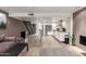 Open-concept kitchen and living space with modern appliances, bar seating, and exposed brick at 7740 E Heatherbrae Ave # 13, Scottsdale, AZ 85251