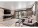 Spacious living room with brick walls, a large sliding door to the outside, and a comfortable sectional sofa at 7740 E Heatherbrae Ave # 13, Scottsdale, AZ 85251