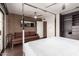 Spacious bedroom featuring wood floors, brick accent wall, sofa, and a closet with drawers at 7740 E Heatherbrae Ave # 13, Scottsdale, AZ 85251