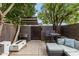 Private patio featuring outdoor seating, fire feature, a grill, and brick walls at 7740 E Heatherbrae Ave # 13, Scottsdale, AZ 85251