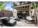 Enclosed patio with hanging chair, outdoor seating, sliding glass doors and lush landscaping at 7740 E Heatherbrae Ave # 13, Scottsdale, AZ 85251