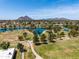 Picturesque aerial view of a community park featuring a lake, green spaces, and mountain views at 8113 E Vista Dr, Scottsdale, AZ 85250