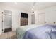 A comfortable bedroom features a ceiling fan, a dresser with a TV, and a bathroom with sliding doors at 8113 E Vista Dr, Scottsdale, AZ 85250