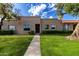 Charming front exterior with well-maintained lawn, desert landscaping, and a welcoming entrance at 8113 E Vista Dr, Scottsdale, AZ 85250