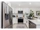Bright kitchen features white cabinets, stainless steel appliances, subway tile backsplash, and quartz countertops at 8113 E Vista Dr, Scottsdale, AZ 85250