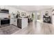 Open-concept kitchen flows to dining area with stainless steel appliances, white cabinetry, and island seating at 8113 E Vista Dr, Scottsdale, AZ 85250