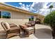 Cozy outdoor seating area with wicker furniture, a grill, and a sunny atmosphere at 8113 E Vista Dr, Scottsdale, AZ 85250