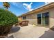Private patio area with wicker seating, lush green landscaping, and a serene outdoor space at 8113 E Vista Dr, Scottsdale, AZ 85250
