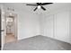 Bright bedroom featuring fresh, neutral paint, ceiling fan and closet at 8132 W Earll Dr, Phoenix, AZ 85033