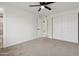 Neutral bedroom featuring fresh, white paint, ceiling fan and closet at 8132 W Earll Dr, Phoenix, AZ 85033