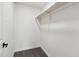 Walk-in closet offering ample storage and organization solutions, featuring carpet and white shelving at 8132 W Earll Dr, Phoenix, AZ 85033