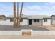 Charming single-story home featuring a minimalist front yard, a well-manicured lawn, and a welcoming entrance at 8132 W Earll Dr, Phoenix, AZ 85033