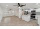 Open-concept living space with updated floors, ceiling fans, and seamless access to the modern kitchen at 8132 W Earll Dr, Phoenix, AZ 85033