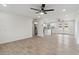 Bright living space featuring modern flooring and open floor plan transitioning to a stylish kitchen at 8132 W Earll Dr, Phoenix, AZ 85033