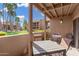 Covered balcony featuring outdoor dining set and views of landscaping at 8250 E Arabian Trl # 120, Scottsdale, AZ 85258