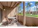 Covered balcony featuring outdoor dining set and palm tree views at 8250 E Arabian Trl # 120, Scottsdale, AZ 85258