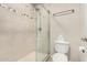 Bright bathroom showcasing walk-in shower with glass doors and modern toilet at 8250 E Arabian Trl # 120, Scottsdale, AZ 85258