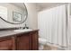 Bathroom featuring vanity with dark wood cabinets, mirror, and shower with curtain at 8250 E Arabian Trl # 120, Scottsdale, AZ 85258