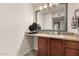 Bathroom featuring granite countertop, wooden vanity, and decorative mirror at 8250 E Arabian Trl # 120, Scottsdale, AZ 85258