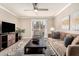 Living room with ceiling fan, tv, and comfortable seating area at 8250 E Arabian Trl # 120, Scottsdale, AZ 85258