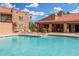 Beautiful community pool with lounge chairs, surrounded by well-maintained grounds and landscaping at 8250 E Arabian Trl # 120, Scottsdale, AZ 85258