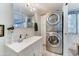 Bathroom featuring a sink, mirror, washer, and dryer at 111 S Greenfield Rd # 670, Mesa, AZ 85206