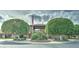 Striking view of the building exterior, showcasing landscaped grounds with manicured trees and an inviting entrance at 111 S Greenfield Rd # 670, Mesa, AZ 85206