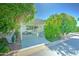 Charming home featuring lush landscaping, a covered porch, and a patio area at 111 S Greenfield Rd # 670, Mesa, AZ 85206