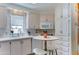 Cozy kitchen area featuring white cabinets, bar stools and a window above the sink at 111 S Greenfield Rd # 670, Mesa, AZ 85206