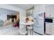 Eat in kitchen featuring white cabinets, bright lighting, and an adjacent living space at 111 S Greenfield Rd # 670, Mesa, AZ 85206