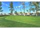 Well-maintained putting green surrounded by mature trees, offering a recreational amenity for golf enthusiasts at 111 S Greenfield Rd # 670, Mesa, AZ 85206