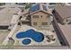 Aerial view of backyard pool with a baja deck, hot tub, and nearby fire pit with chairs at 11183 W Tonto St, Avondale, AZ 85323