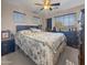 Bedroom with ceiling fan, two windows, and a large bed at 11183 W Tonto St, Avondale, AZ 85323