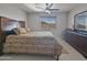 Bedroom featuring ceiling fan, wood-look headboard and accents, and a window letting in ample natural light at 11183 W Tonto St, Avondale, AZ 85323
