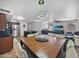 Open concept dining area with modern lighting fixture, with an adjoining kitchen and living room at 11183 W Tonto St, Avondale, AZ 85323