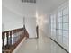 Bright hallway with smooth floors and wooden banister and a hallway with clean white doors at 11183 W Tonto St, Avondale, AZ 85323