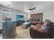 Relaxing living room with comfortable seating, a ceiling fan, and a view of the outdoors at 11183 W Tonto St, Avondale, AZ 85323