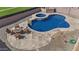 Backyard pool with a baja deck, hot tub, and nearby fire pit with chairs at 11183 W Tonto St, Avondale, AZ 85323